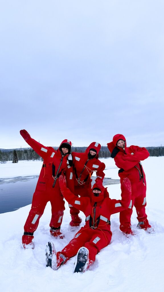 Guests in floating suits on the snowy shore
